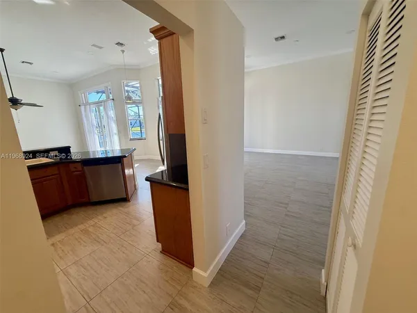an empty room with a window and a ceiling fan