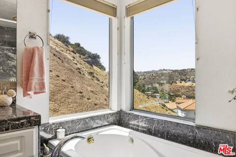 a bathroom with a bathtub and shower