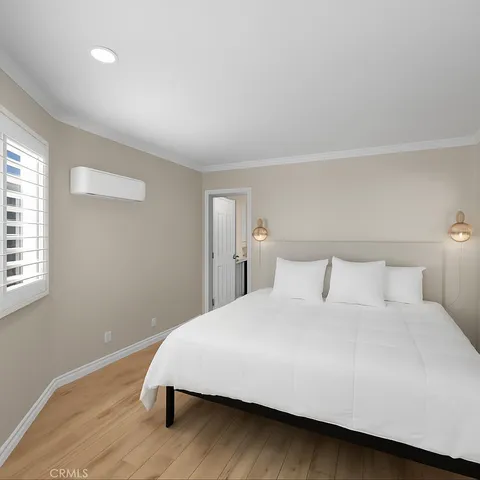 a bedroom with a bed and a night stand