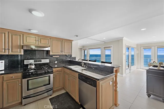 a kitchen with stainless steel appliances a stove sink microwave and cabinets