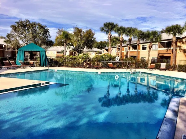 a view of swimming pool with outdoor seating