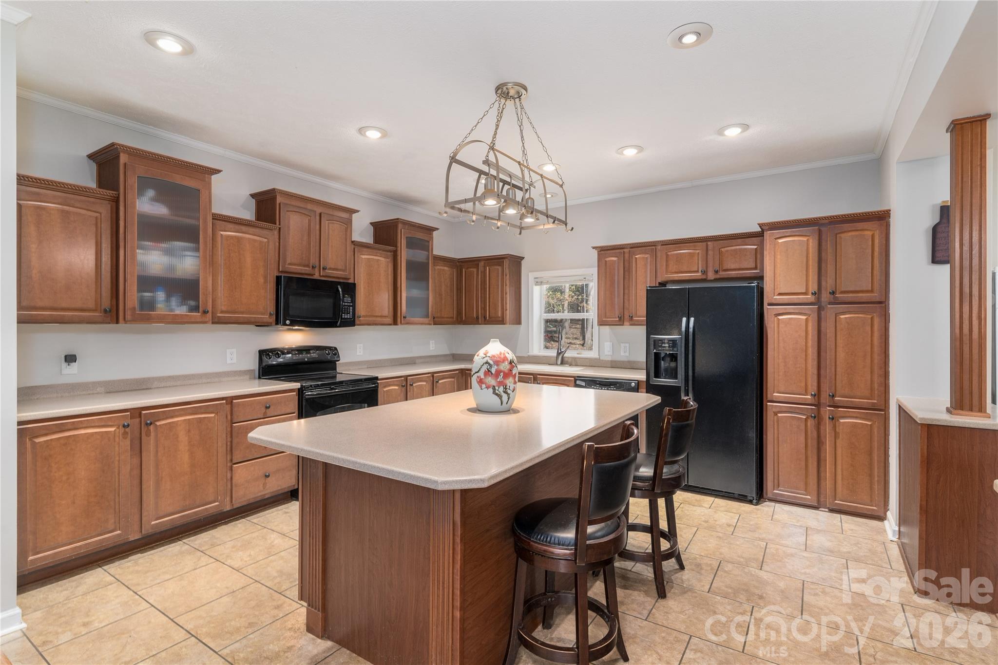 296 Stillwater Road Troutman, NC 28166 - Photo 18 of 33 a kitchen with stainless steel appliances a sink a stove a refrigerator cabinets and chairs