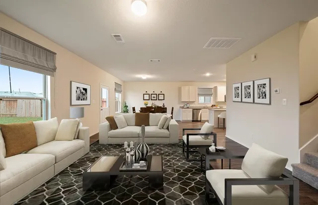 a living room with furniture wooden floor and a large window