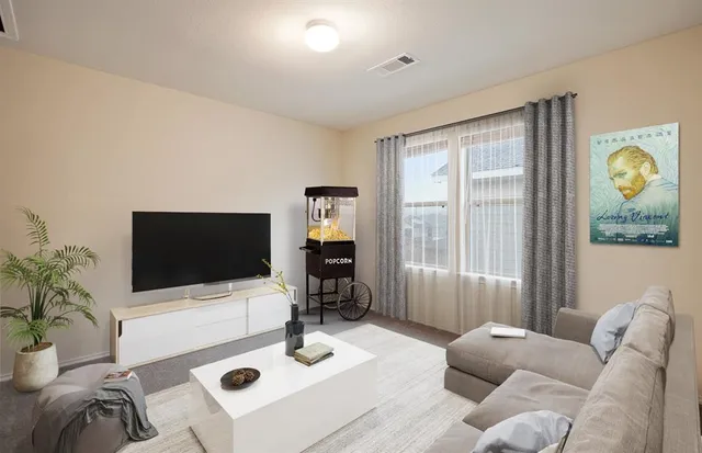 a living room with furniture and a flat screen tv