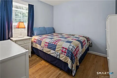 a spacious bedroom with a bed a couch and dresser