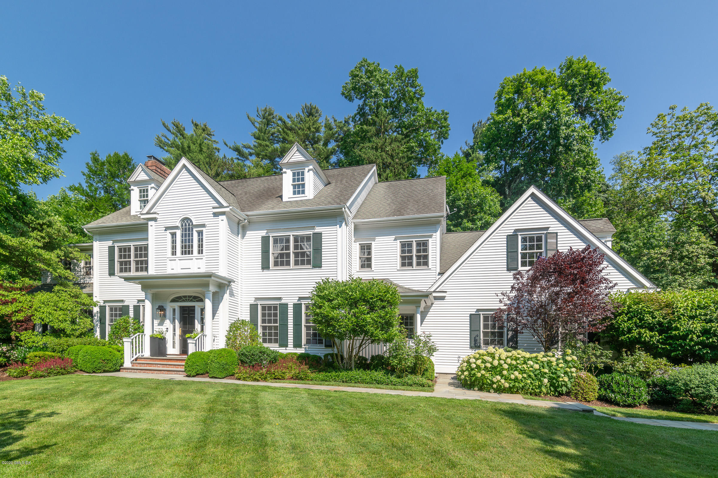 123 Valley Drive Greenwich, CT 06831 - Photo 1 of 48 a front view of a house with a yard