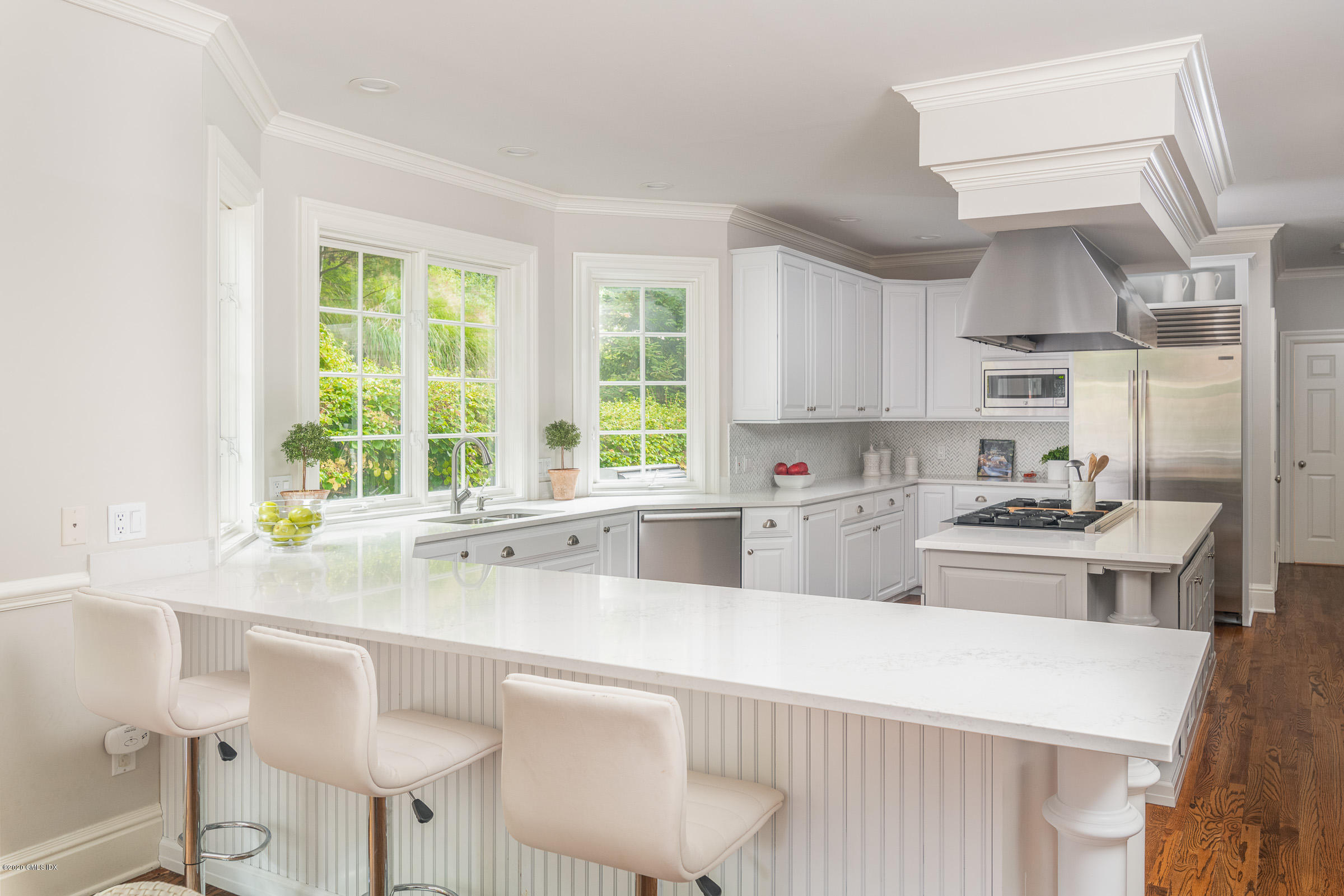 123 Valley Drive Greenwich, CT 06831 - Photo 12 of 48 a kitchen with stainless steel appliances a sink a stove a table and chairs