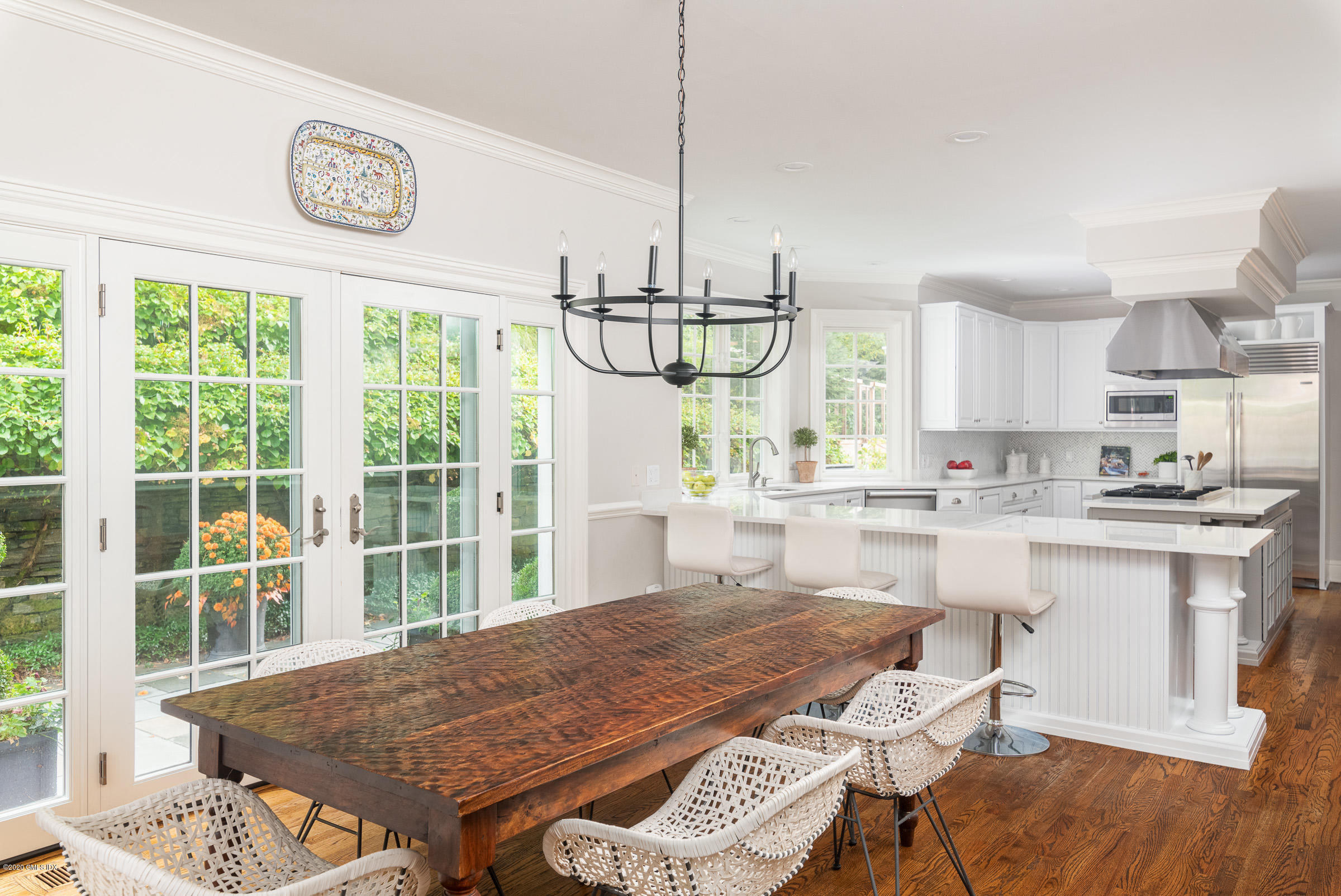 123 Valley Drive Greenwich, CT 06831 - Photo 13 of 48 a kitchen with stainless steel appliances granite countertop a stove a kitchen island a table and chairs in it