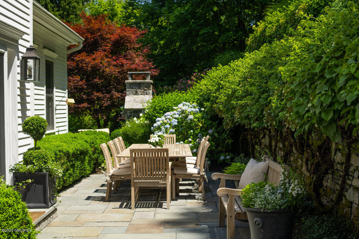123 Valley Drive Greenwich, CT 06831 - Photo 34 of 48 a view of a patio with table and chairs and potted plants