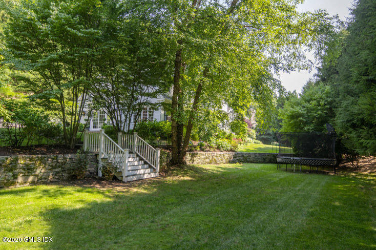 123 Valley Drive Greenwich, CT 06831 - Photo 36 of 48 a view of a garden with a slide and a tree