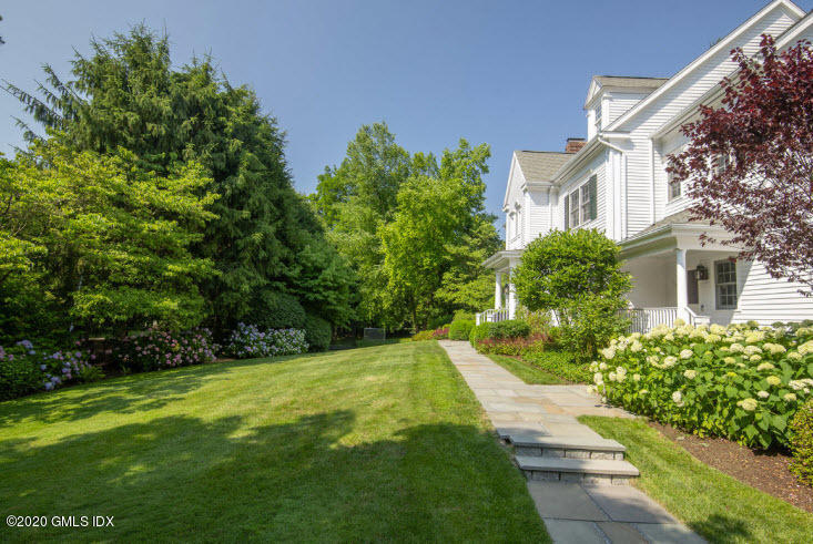 123 Valley Drive Greenwich, CT 06831 - Photo 39 of 48 a view of a house with a yard and potted plants