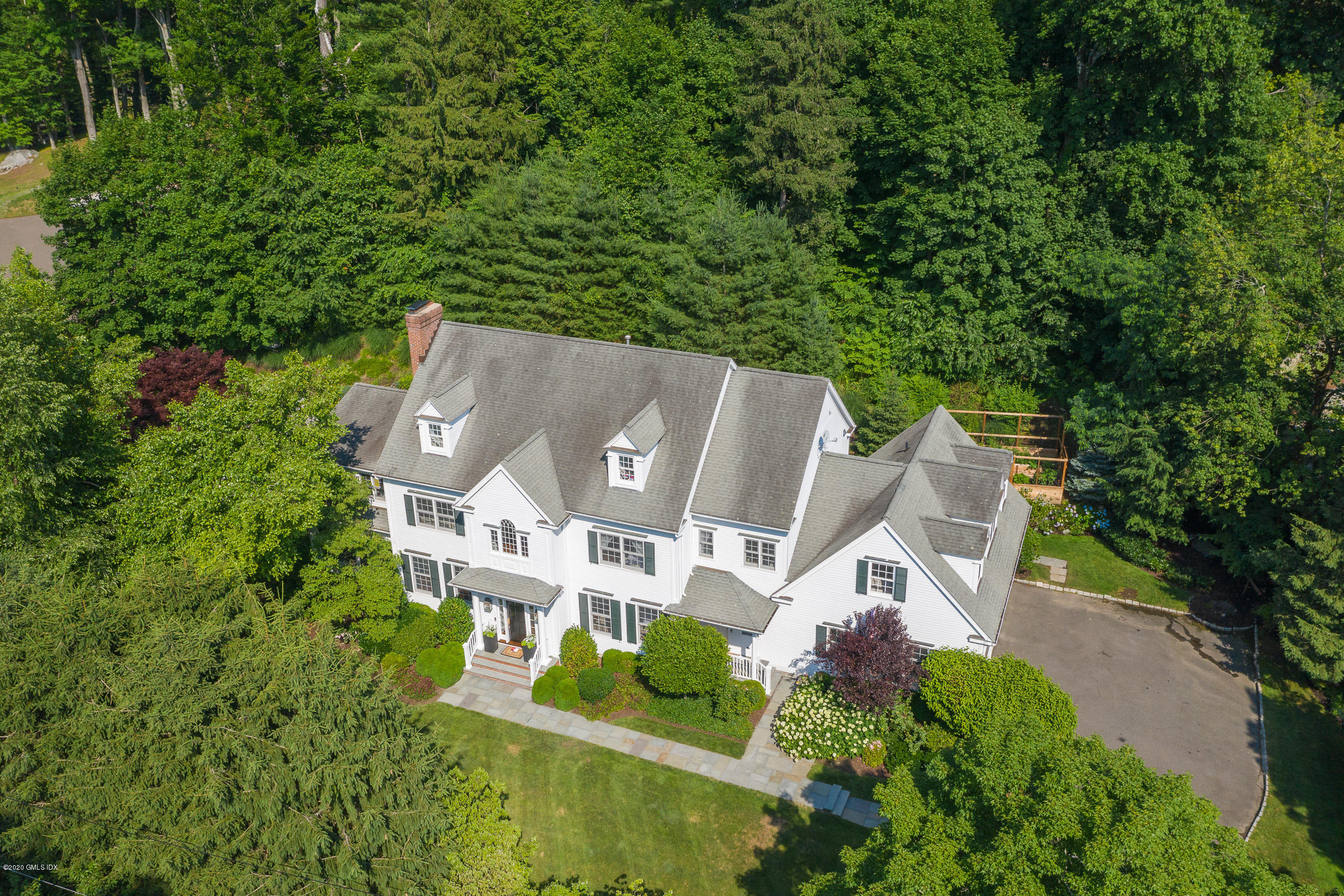 123 Valley Drive Greenwich, CT 06831 - Photo 42 of 48 an aerial view of a house with a yard and trees all around