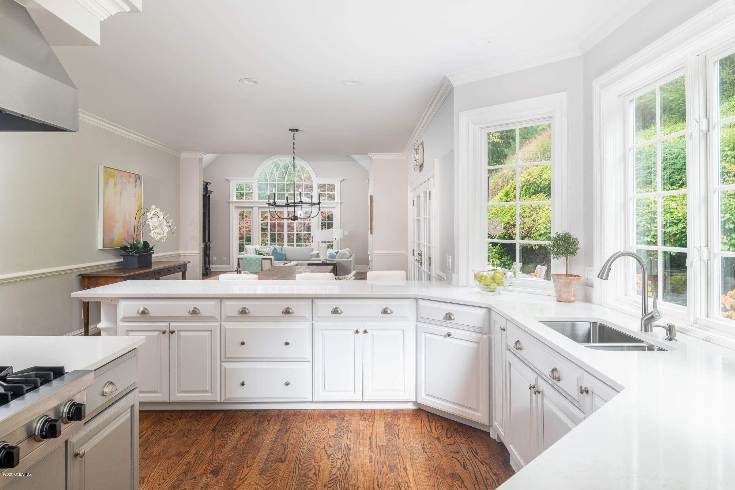 123 Valley Drive Greenwich, CT 06831 - Photo 8 of 48 a large white kitchen with a large window a sink and white stainless steel appliances