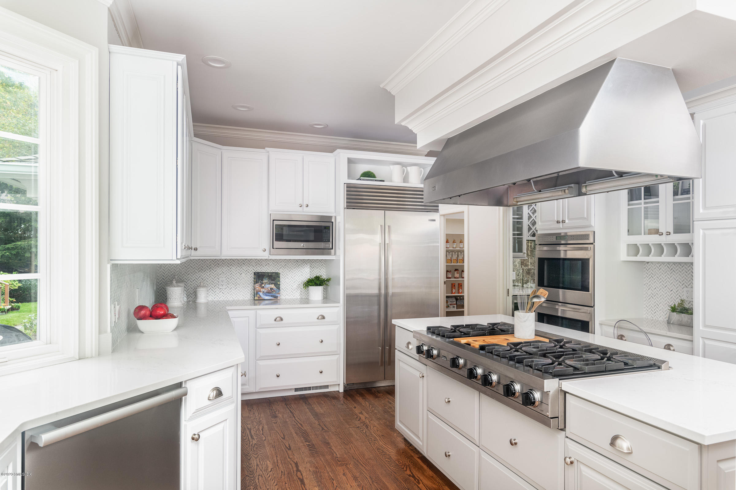 123 Valley Drive Greenwich, CT 06831 - Photo 10 of 48 a kitchen with stainless steel appliances a stove a refrigerator and a cabinets