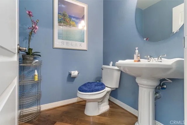 a view of a hallway with wooden floor and door