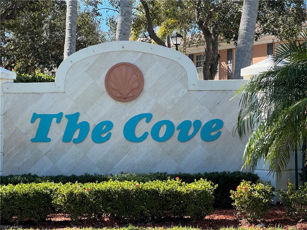 5365 Cove Circle, Unit 125 Naples, FL 34119 - Photo 1 of 36 view of outdoor space with a sign and trees