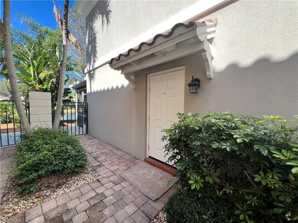 5365 Cove Circle, Unit 125 Naples, FL 34119 - Photo 23 of 36 a backyard of a house with lots of green space