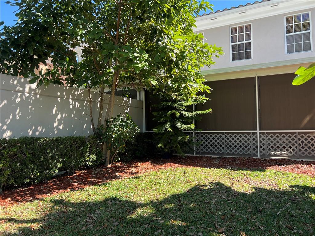 5365 Cove Circle, Unit 125 Naples, FL 34119 - Photo 25 of 36 a view of a backyard of the house