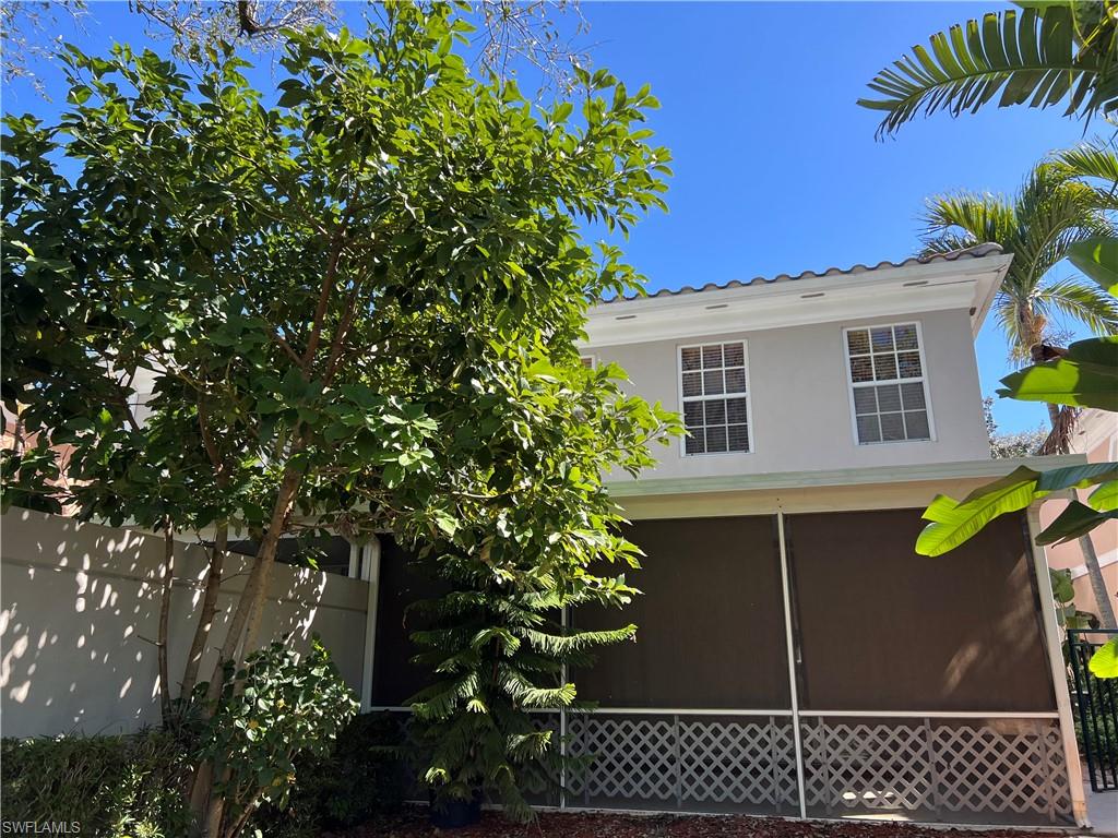 5365 Cove Circle, Unit 125 Naples, FL 34119 - Photo 27 of 36 a view of a house with a backyard