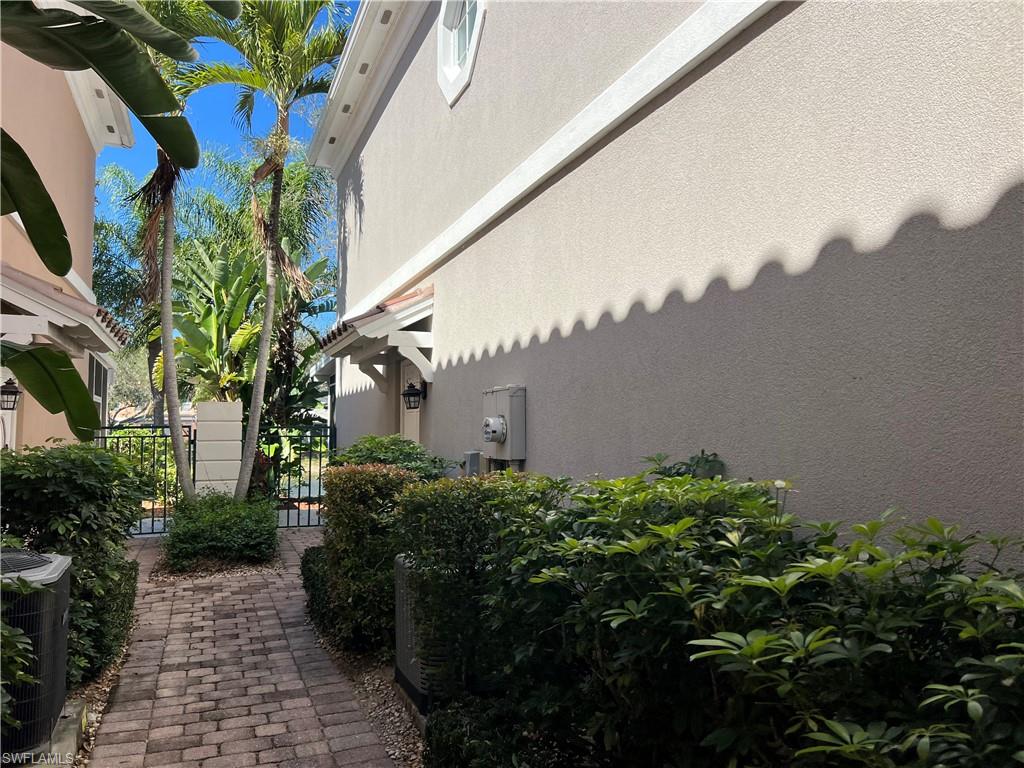 5365 Cove Circle, Unit 125 Naples, FL 34119 - Photo 29 of 36 a backyard of a house with lots of green space