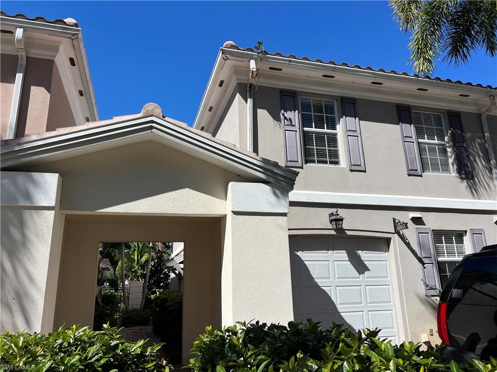 5365 Cove Circle, Unit 125 Naples, FL 34119 - Photo 30 of 36 a view of a house with a garage