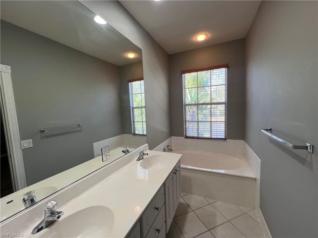 5365 Cove Circle, Unit 125 Naples, FL 34119 - Photo 32 of 36 a bathroom with a sink and a bathtub