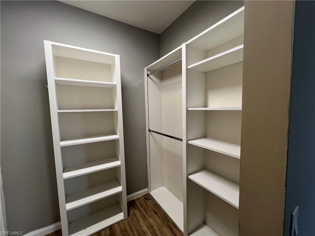 5365 Cove Circle, Unit 125 Naples, FL 34119 - Photo 33 of 36 a view of walk in closet with empty racks