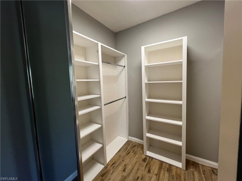 5365 Cove Circle, Unit 125 Naples, FL 34119 - Photo 34 of 36 a view of walk in closet with empty racks