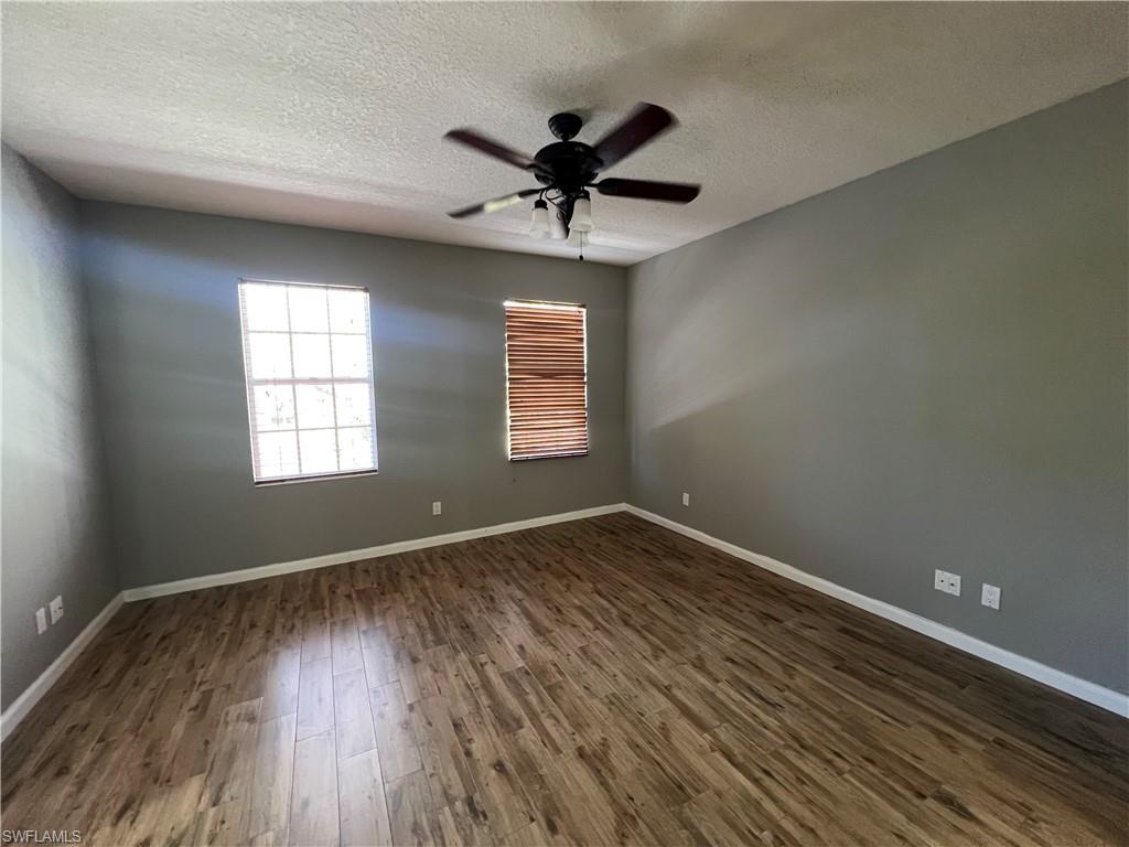 5365 Cove Circle, Unit 125 Naples, FL 34119 - Photo 35 of 36 wooden floor in an empty room with a window