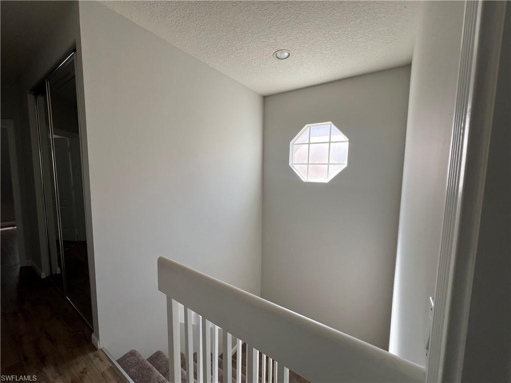 5365 Cove Circle, Unit 125 Naples, FL 34119 - Photo 9 of 36 a view of staircase with rug
