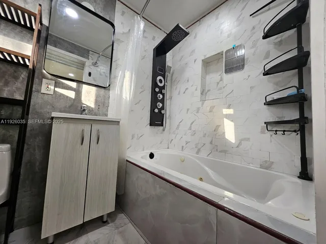 a bathroom with a bathtub and a shower