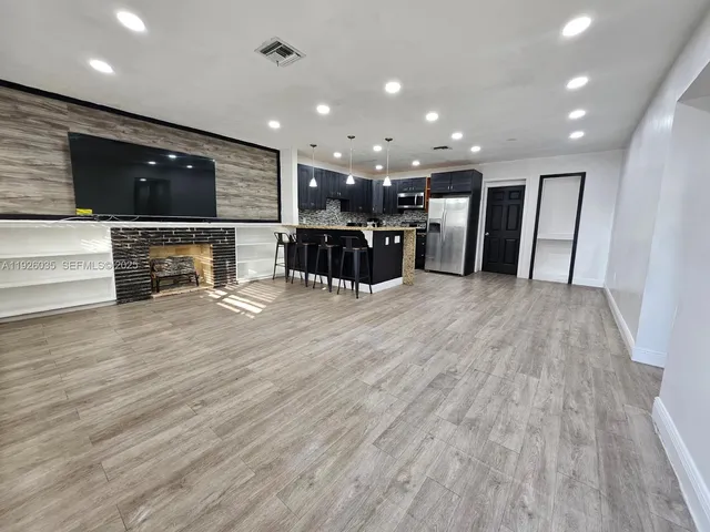 a lobby with furniture and a flat screen tv