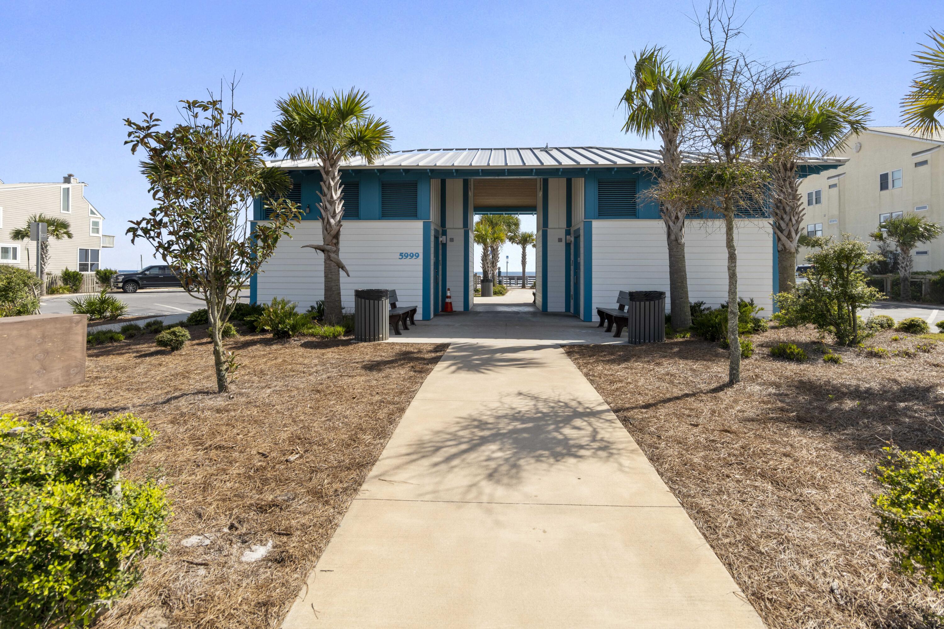 145 Walnut Street Santa Rosa Beach, FL 32459 - Photo 16 of 38 a front view of a house with a yard outdoor seating and covered with trees