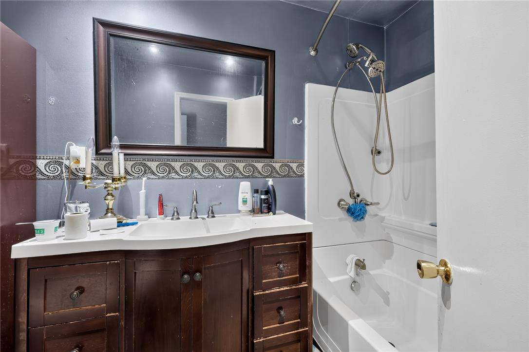 2882 Locust Ridge Road Pocono Lake, PA 18347 - Photo 36 of 45 A well-appointed bathroom offers a convenient vanity with a mirror and a clean tub and shower combination.