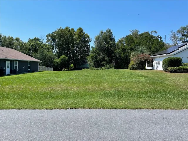 a view of a garden with a house in the background