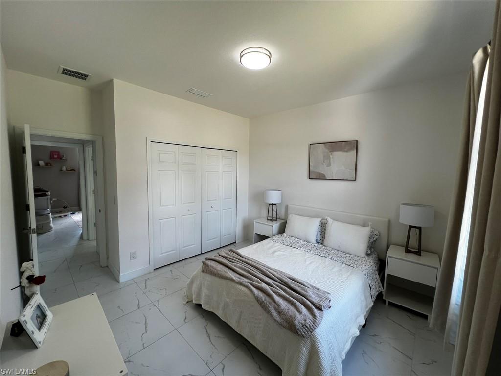 3313 68th Street West Lehigh Acres, FL 33971 - Photo 23 of 26 Bedroom with visible vents, marble finish floor, and a closet