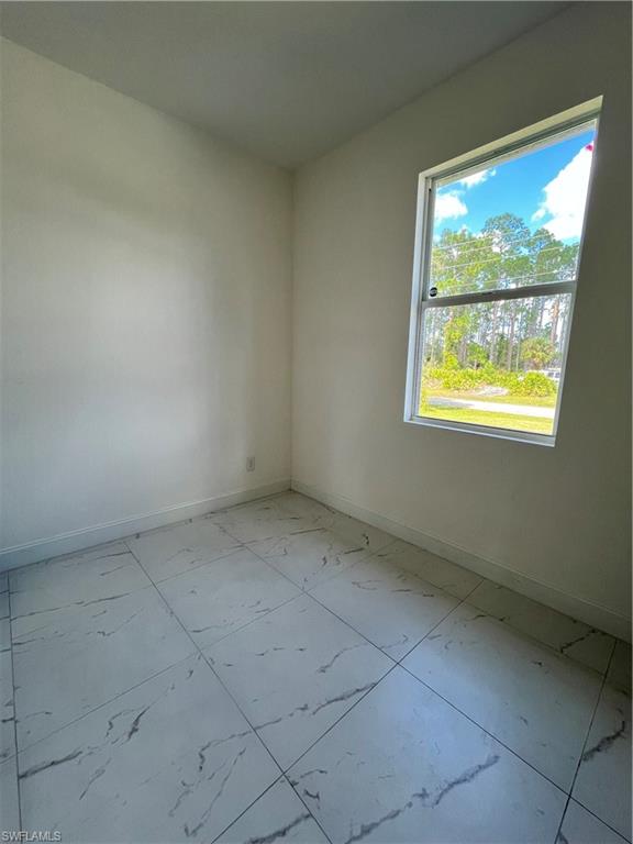 3313 68th Street West Lehigh Acres, FL 33971 - Photo 24 of 26 Empty room with light marble finish floors