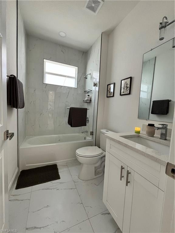 3313 68th Street West Lehigh Acres, FL 33971 - Photo 26 of 26 Full bath with vanity, shower / bathtub combination, and light marble finish flooring