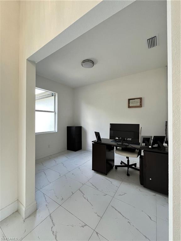 3313 68th Street West Lehigh Acres, FL 33971 - Photo 6 of 26 Office area with marble finish floor, baseboards, and visible vents
