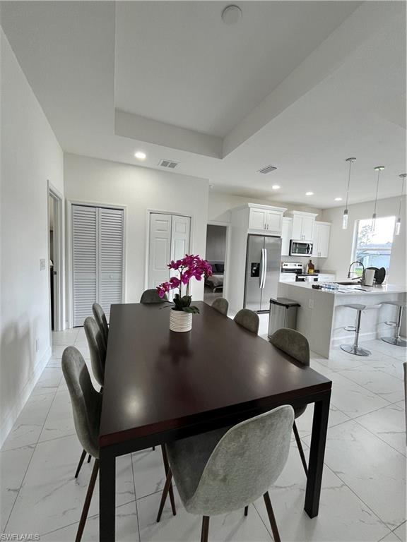 3313 68th Street West Lehigh Acres, FL 33971 - Photo 10 of 26 Dining room featuring marble finish floor, baseboards, visible vents, and recessed lighting
