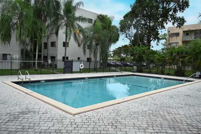 a view of a swimming pool with a table and chairs