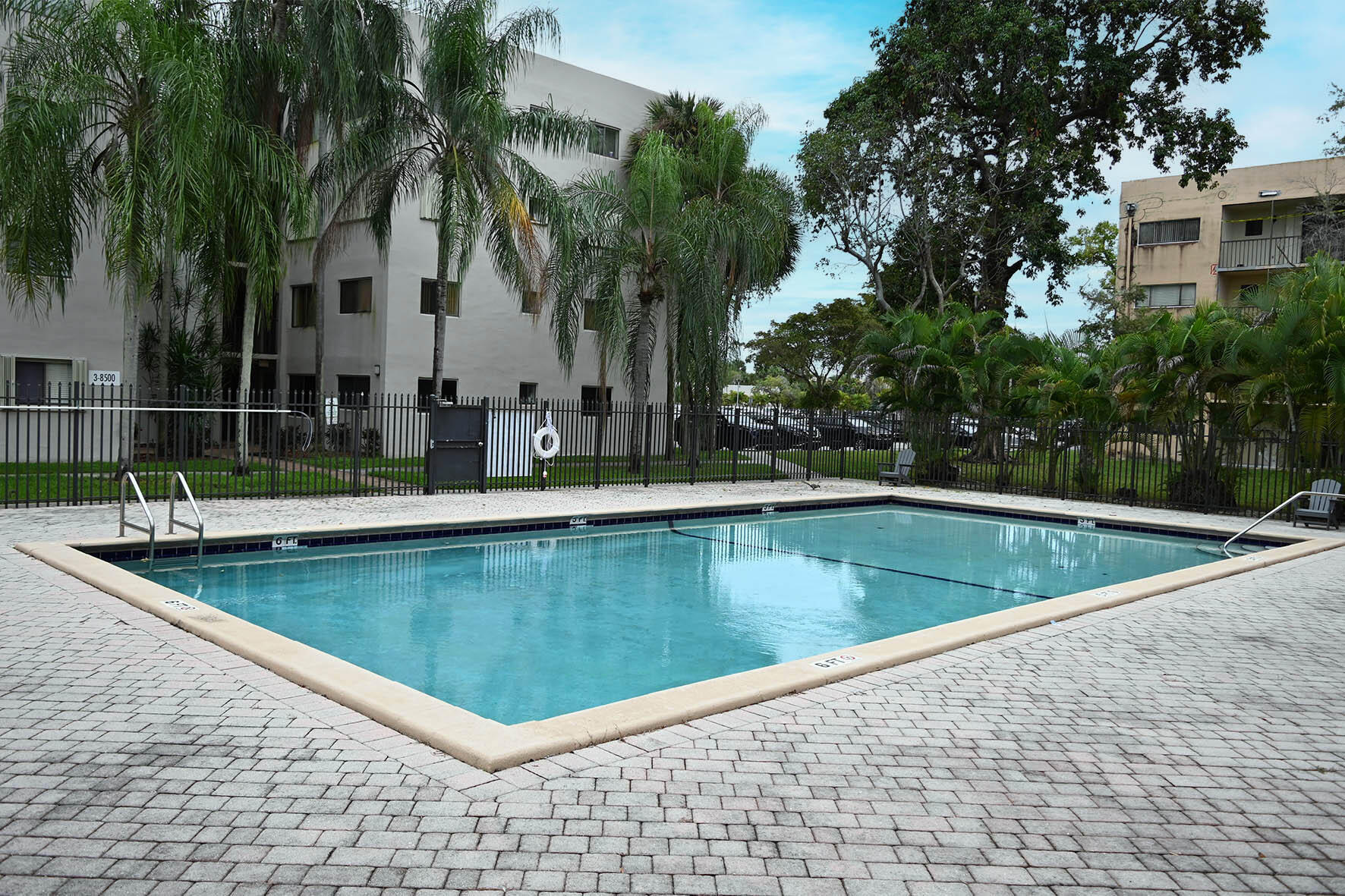 a view of a swimming pool with a table and chairs