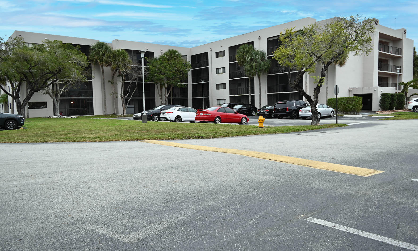 8400 Southwest 133rd Avenue Road, Unit 311 Miami, FL 33183 - Photo 2 of 11 a view of a house with a yard and table and chairs under an umbrella