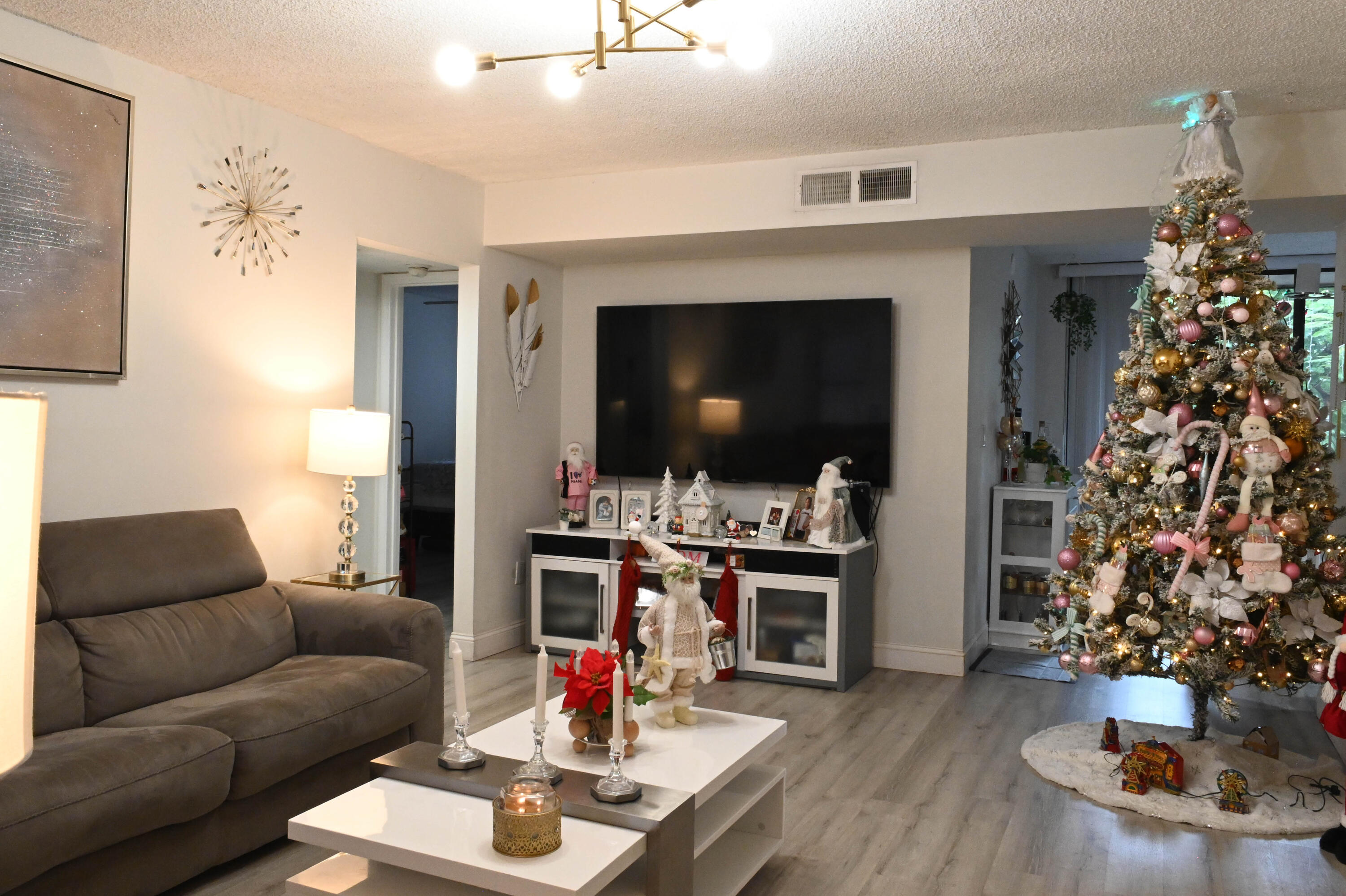 8400 Southwest 133rd Avenue Road, Unit 311 Miami, FL 33183 - Photo 7 of 11 a living room with furniture and a flat screen tv