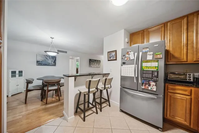 a kitchen with stainless steel appliances granite countertop a refrigerator and a stove top oven
