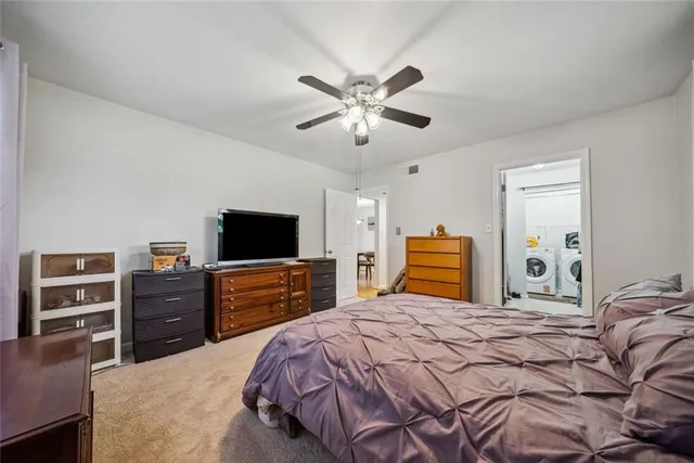a bedroom with a bed and dresser with window