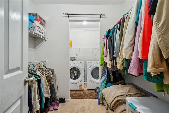 a view of walk in closet with clothes and shoes