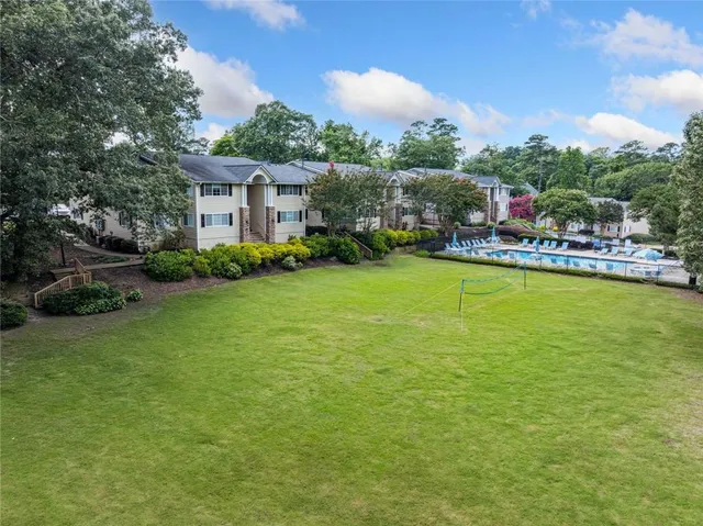 a view of a house with a big yard and potted plants