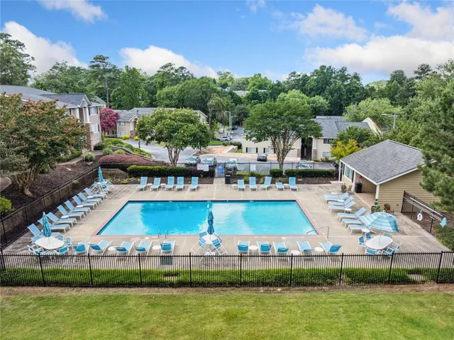 a aerial view of a house with a yard basket ball court and outdoor seating