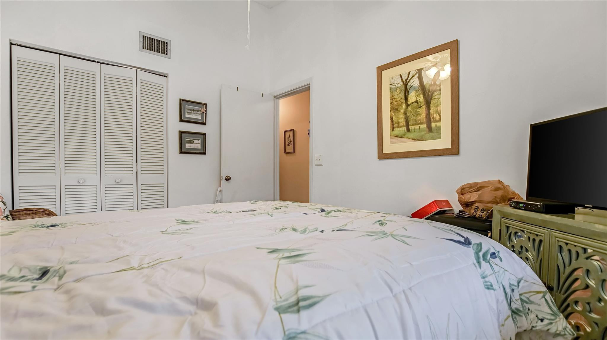 4285 South Pine Island Road, Unit 4285 Davie, FL 33328 - Photo 21 of 35 a bedroom with a bed and a flat screen tv